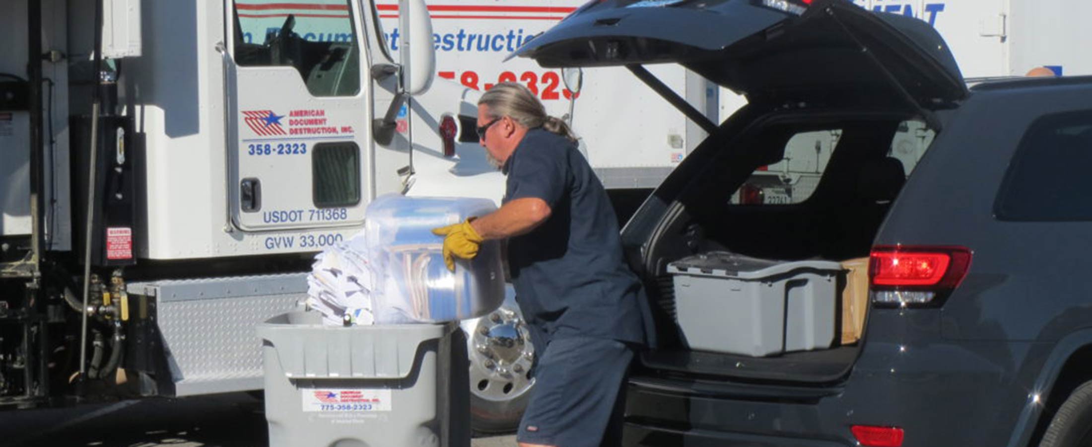 American Document Destruction worker emptying paper into bin